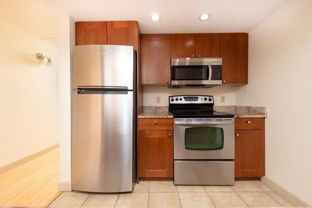a kitchen with a refrigerator and a stove