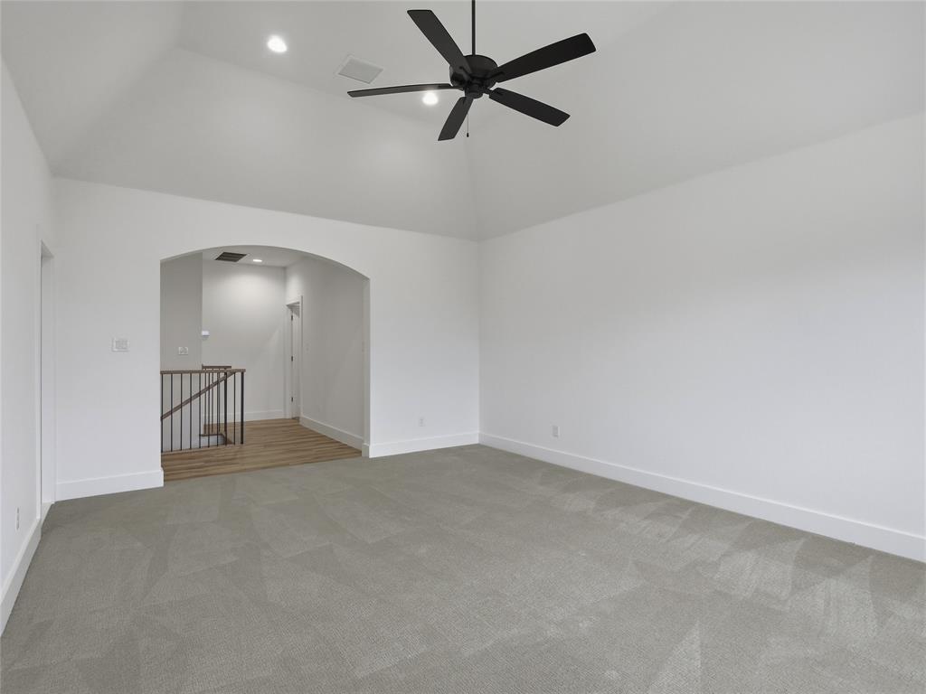 4211 Azalea Way Midlothian, TX 76065 - Photo 30 of 39 Spacious room featuring vaulted ceilings, a contemporary ceiling fan with integrated lighting, recessed lighting, and soft gray carpeting