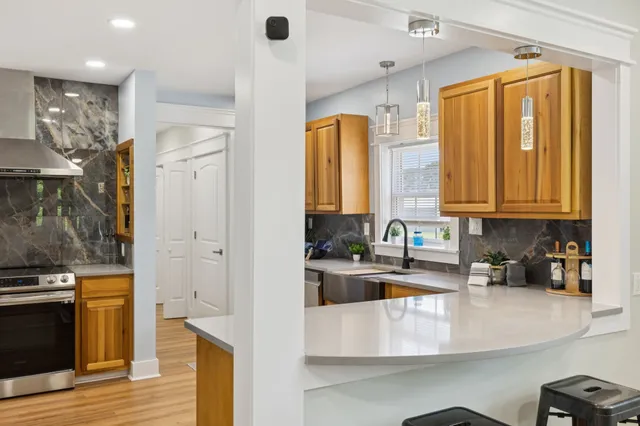 a kitchen with a stove a sink and a refrigerator