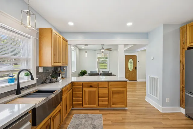 a view of a kitchen with fridge and rack