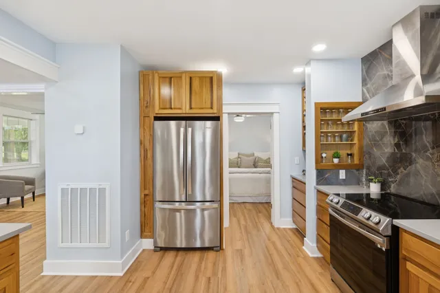 a bedroom with a large bed and chandelier