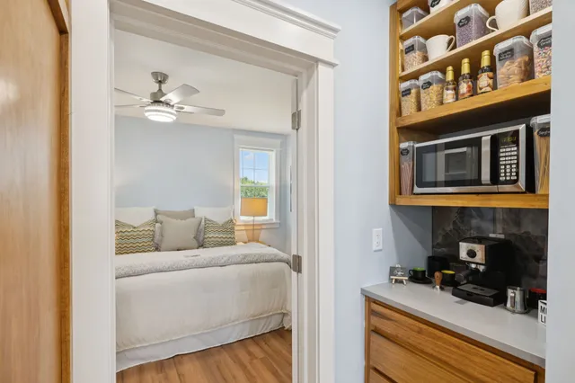 a bedroom with a bed and a view of kitchen