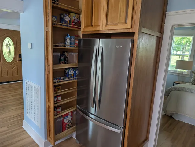 a bedroom with a bed and wooden floor