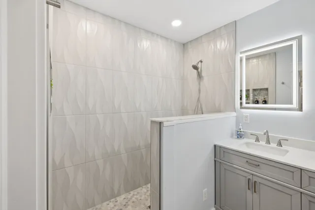 a bathroom with a shower and a sink