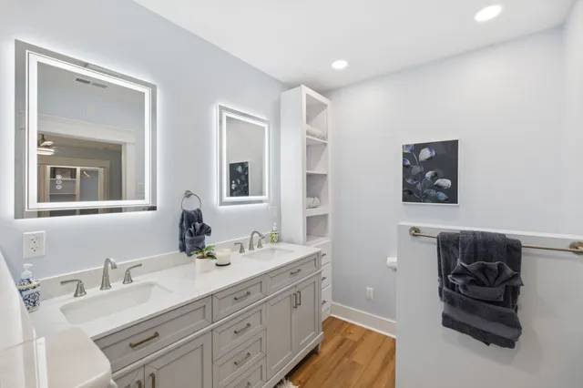a view of walk in closet with wooden floor