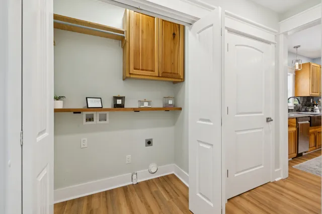 a white house that has a tree in front of it