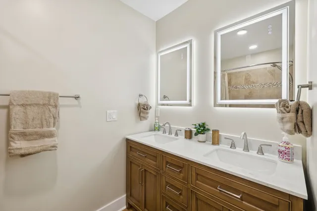 an aerial view of ocean with residential houses with outdoor space and trees
