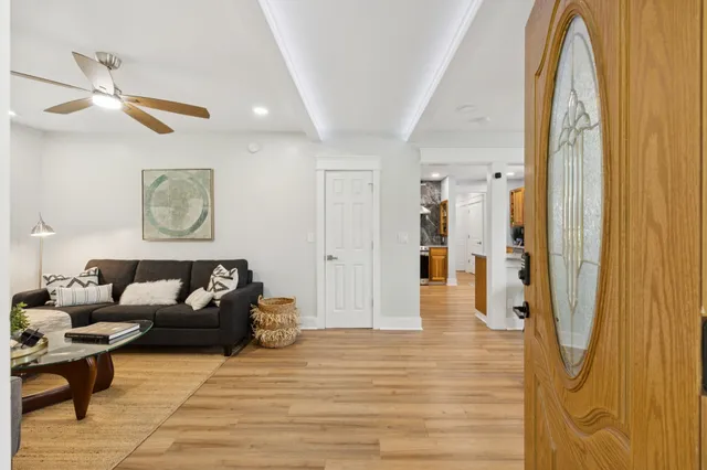 a living room with furniture and a potted plant