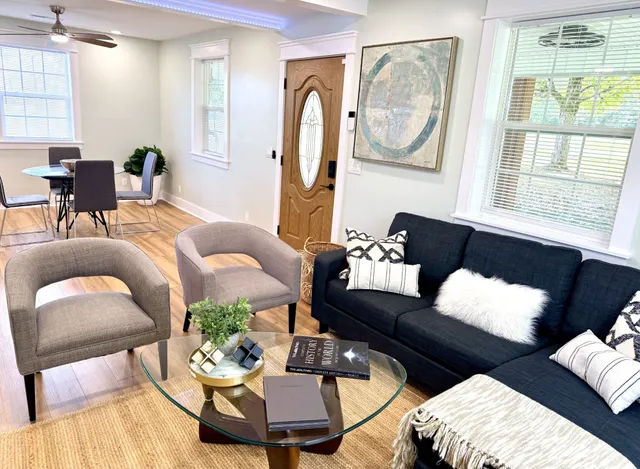 a living room with furniture and wooden floor