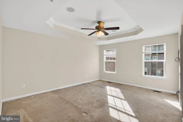 a view of room with a ceiling fan and window