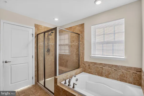 a bathroom with a bathtub and a shower