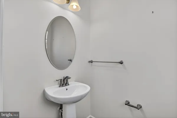 a bathroom with a sink a mirror and a shower