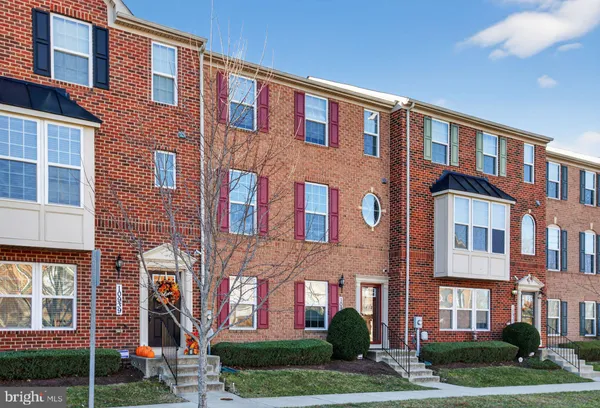 front view of a brick house with a yard