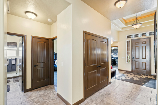 210 Talon Court Ivins, UT 84738 - Photo 25 of 60 Foyer with light tile patterned floors and a tray ceiling