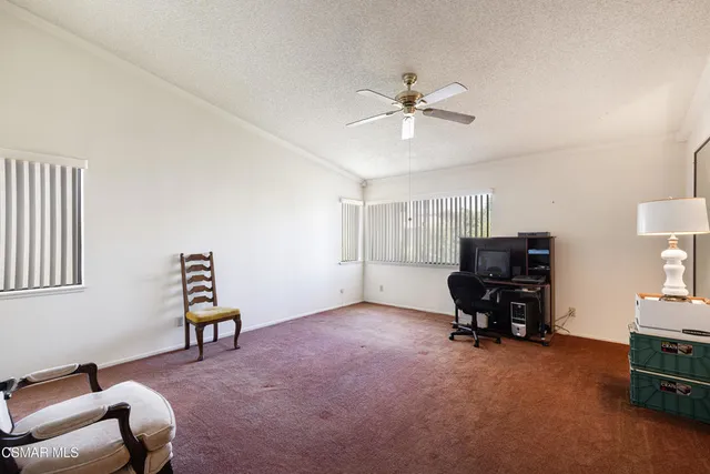 a view of workspace with furniture cabinet and window
