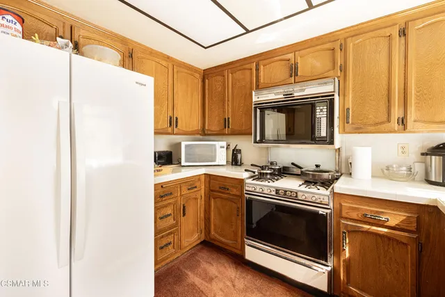 a kitchen with stainless steel appliances granite countertop a stove and a microwave