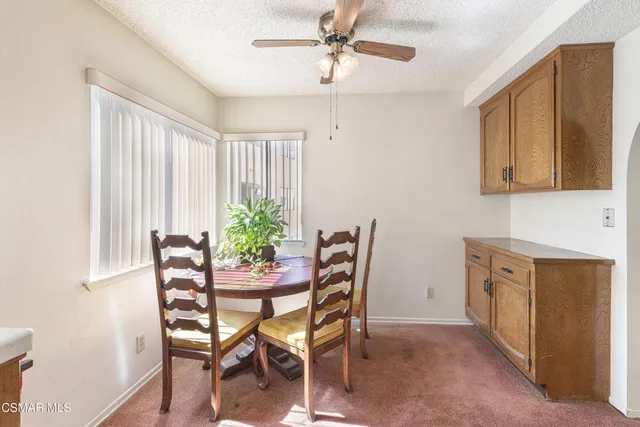 a dining room with furniture and window