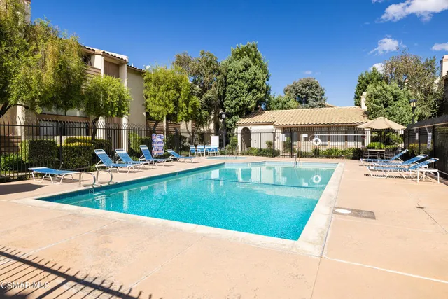 a view of a house with swimming pool and sitting area
