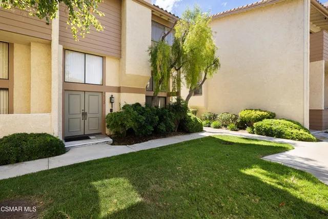 a view of an house with backyard space and garden