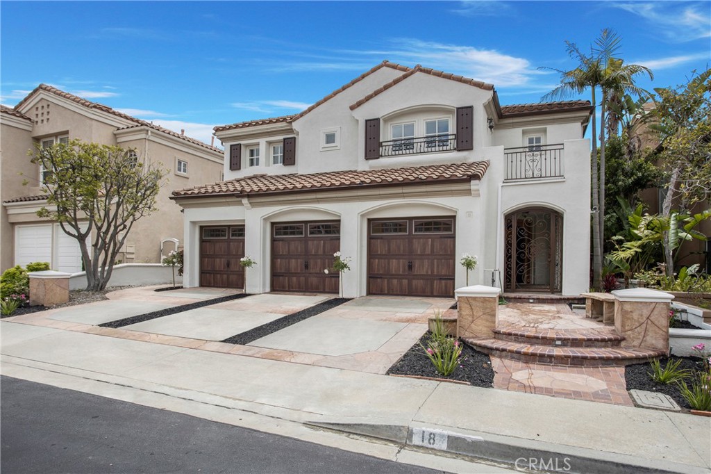 a front view of a house with yard and parking
