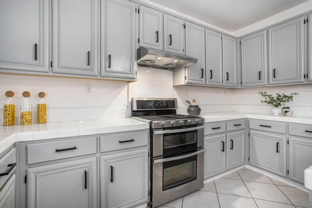 a kitchen with stainless steel appliances a sink and cabinets