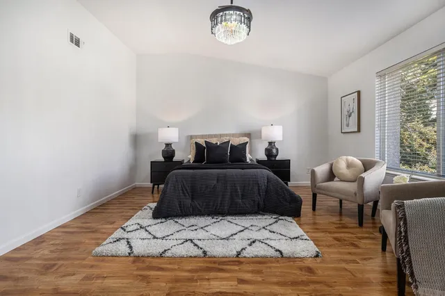 a bedroom with a bed and wooden floor