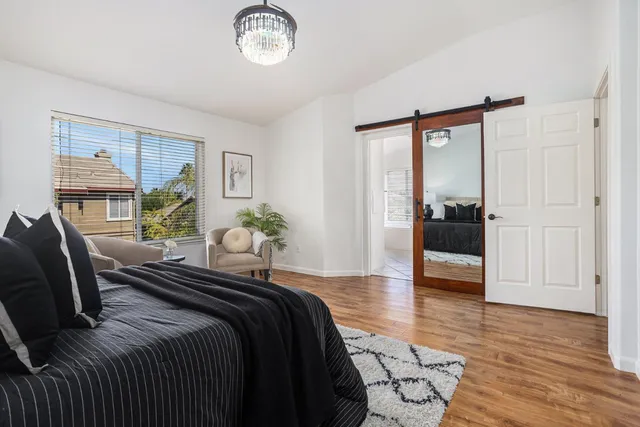 a spacious en suite bathroom with a granite countertop sink mirror and bathtub