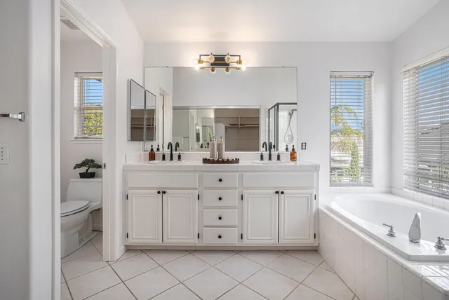 a bathroom with a tub shower and sink