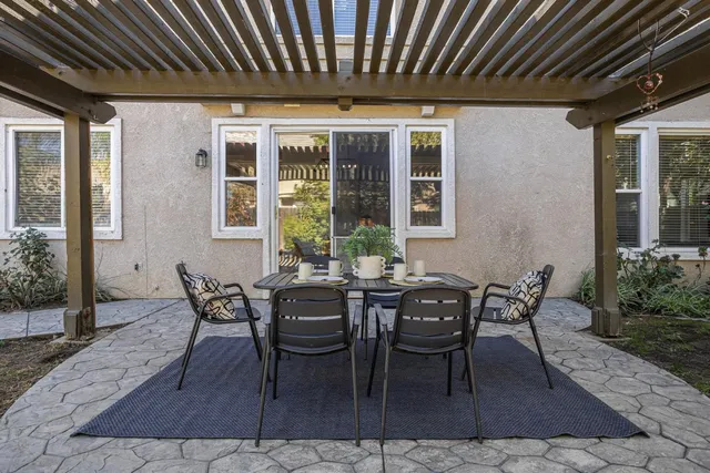 a view of a house with backyard and sitting area
