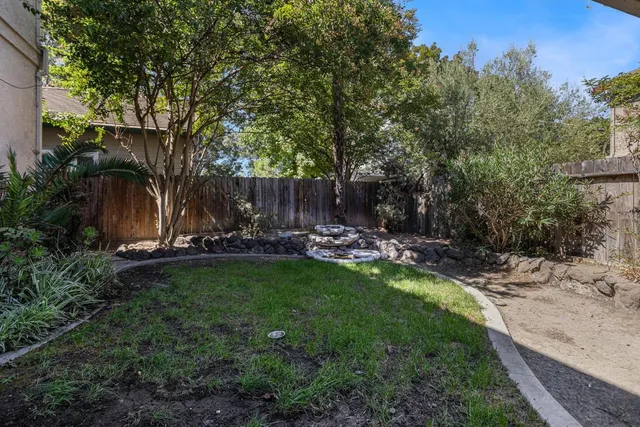 a view of a patio with table and chairs and potted plants