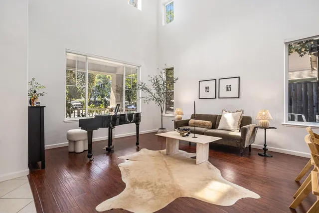 a living room with furniture wooden floor and a large window