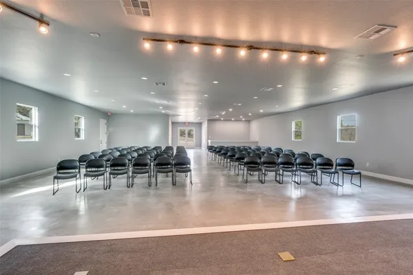 a room with lots of tables and chairs