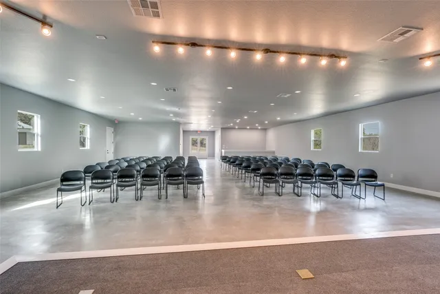 a room with lots of tables and chairs