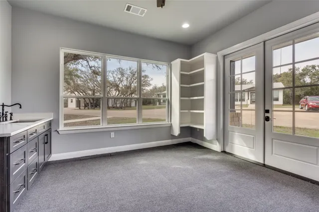 a view of an empty room with a large window