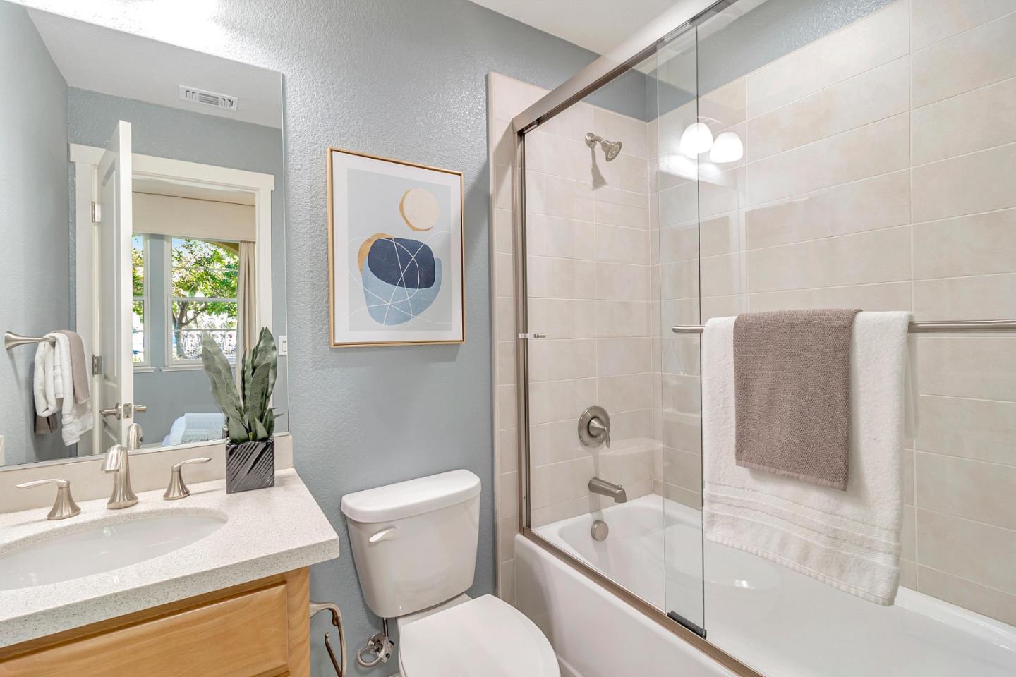 301 Pine Way Mountain View, CA 94041 - Photo 16 of 20 a bathroom with a granite countertop sink toilet a mirror and shower