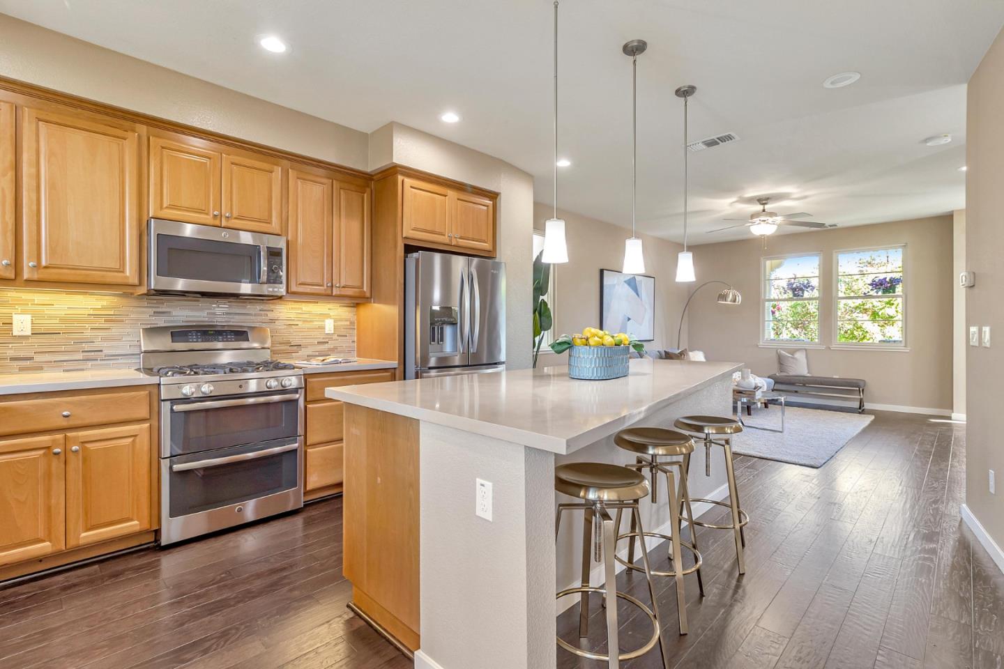 301 Pine Way Mountain View, CA 94041 - Photo 6 of 20 a kitchen with stainless steel appliances kitchen island granite countertop a stove top oven a sink a dining table and chairs with wooden floor
