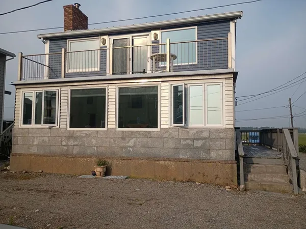 a front view of a house with a large window