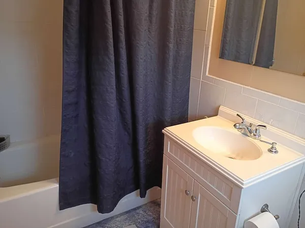 a bathroom with a sink vanity and a mirror