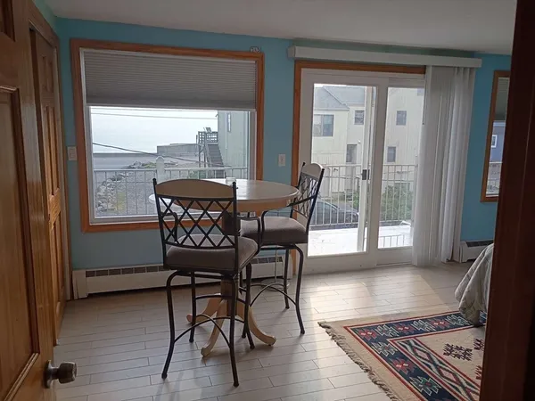 a view of a dining room with furniture wooden floor and a rug