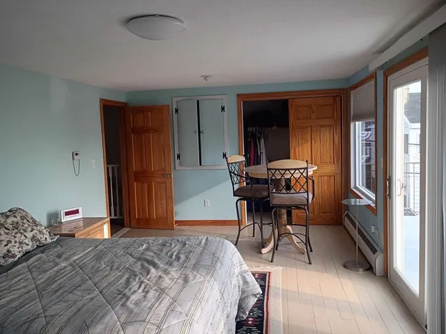 a bedroom with a bed and a table in it