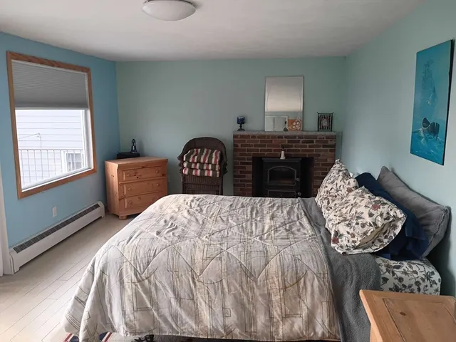 a bedroom with a bed and dresser with mirror