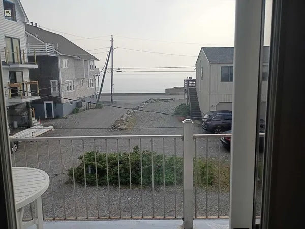 a balcony with table and chairs