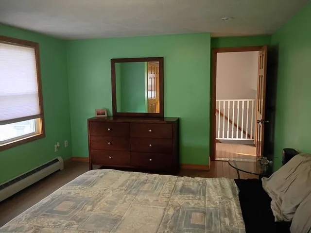 a bedroom with a bed and a dresser