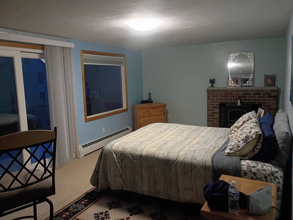 6 Tilden Avenue Scituate, MA 02066 - Photo 28 of 34 a bedroom with a bed and wooden floor