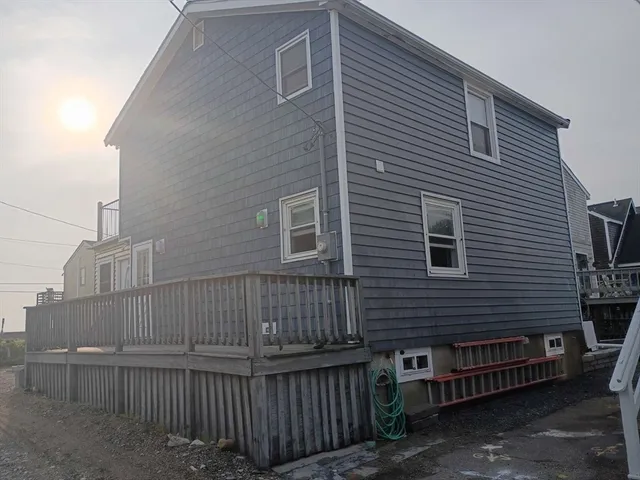 a view of a house with wooden fence