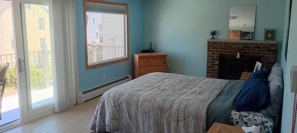 a bedroom with a bed and a fireplace