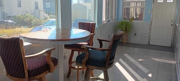 a dining room with furniture and window