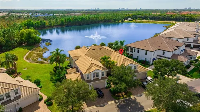 an aerial view of house with yard and lake view