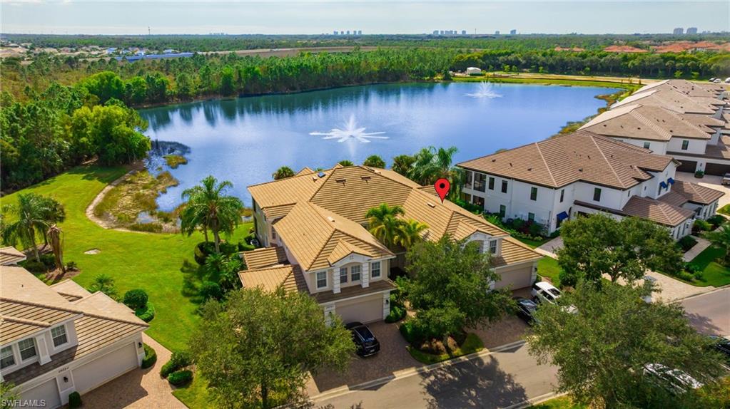 19741 Marino Lake Circle, Unit 802 Miromar Lakes, FL 33913 - Photo 1 of 38 an aerial view of house with yard and lake view