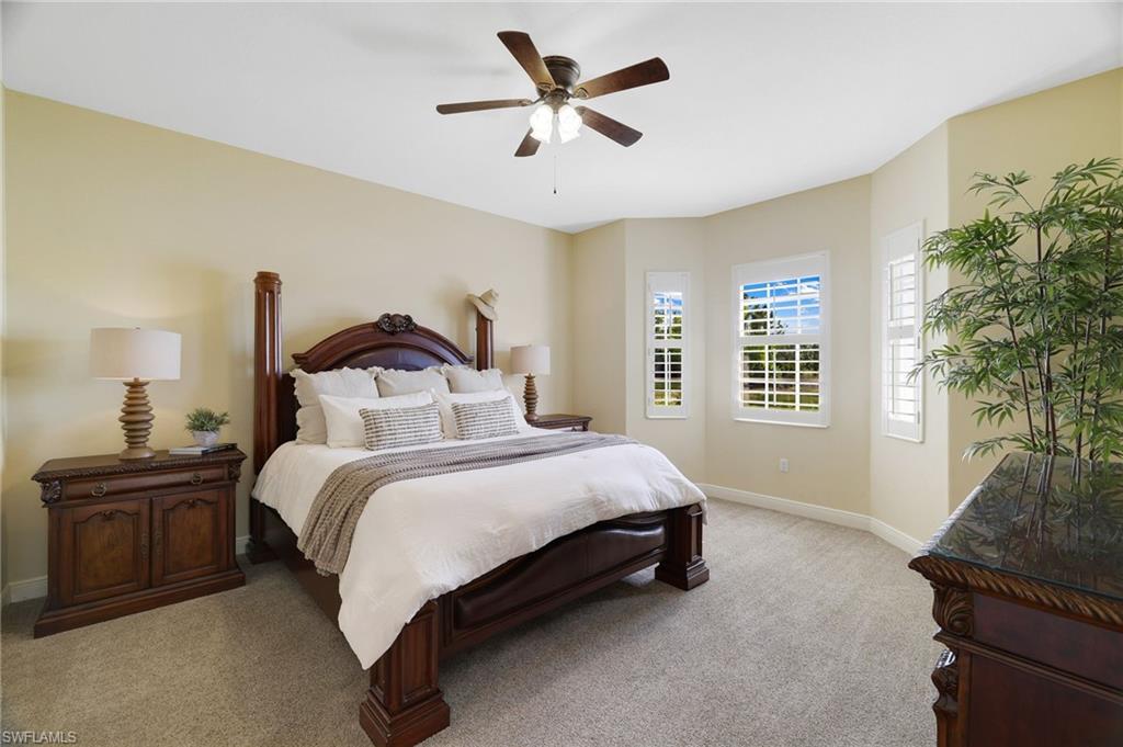 19741 Marino Lake Circle, Unit 802 Miromar Lakes, FL 33913 - Photo 12 of 38 a bedroom with a bed and a large window